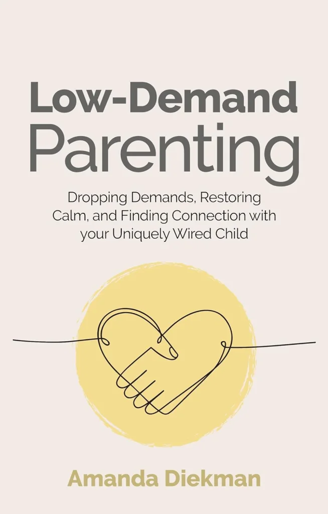 Book cover of "Low-Demand Parenting" by Amanda Diekman. Features line-drawn heart hand, yellow circle on pale pink background, calming theme.