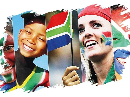 Faces with South African flag face paint and a child holding the flag, smiling. Vibrant colors and energetic mood.