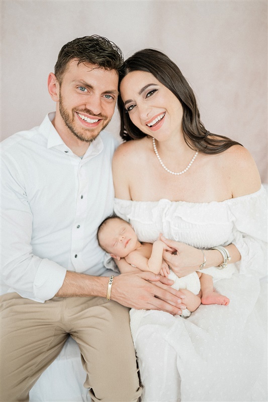 Portrait of mom and dad with newborn
