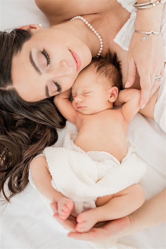 Close-up portrait of mom and newborn sleeping