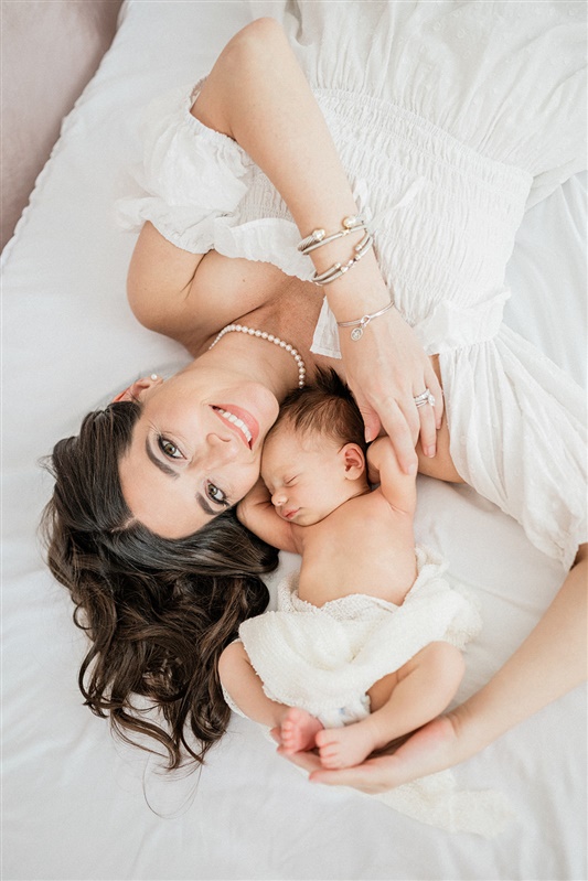 Mom, smiling with newborn baby