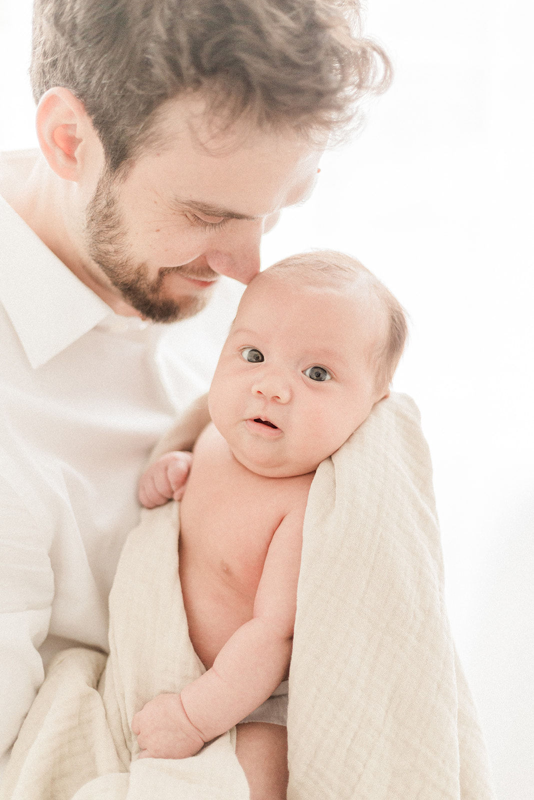 Dad hugging newborn baby