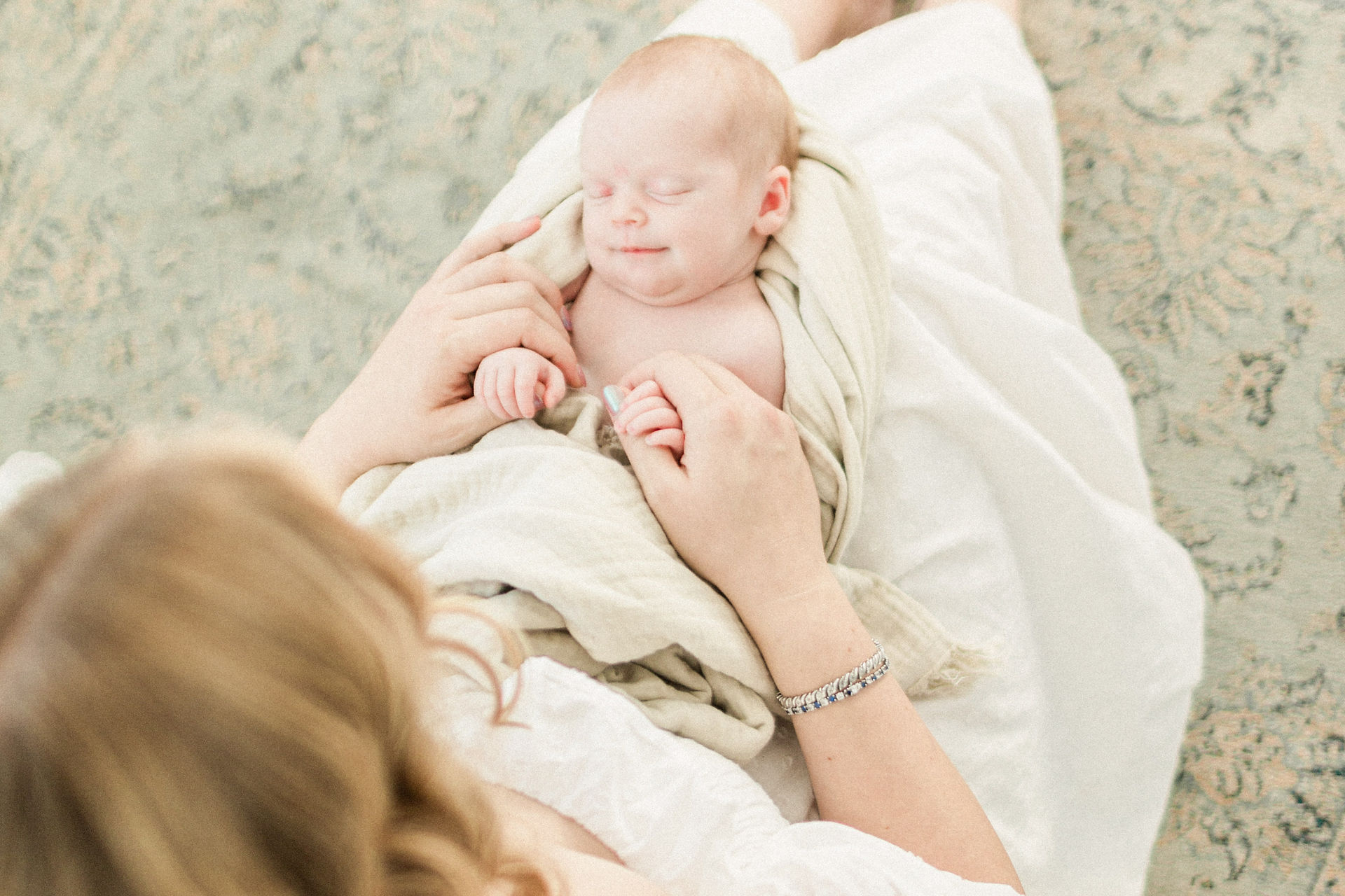 mom holding baby smiling