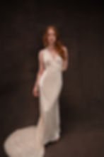 Model wearing Old Hollywood style vintage Vera Wang wedding dress against brown backdrop at Atlanta bridal shop