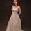 Thumbnail: Model wearing vintage crochet lace wedding dress against brown backdrop in Atlanta bridal shop