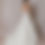 Thumbnail: Dark haired model wearing dropped waist vintage Vera Wang Sex and the City wedding dress against backdrop
