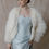 Thumbnail: Model wearing blue vintage wedding dress against beige backdrop at bridal shop in Atlanta