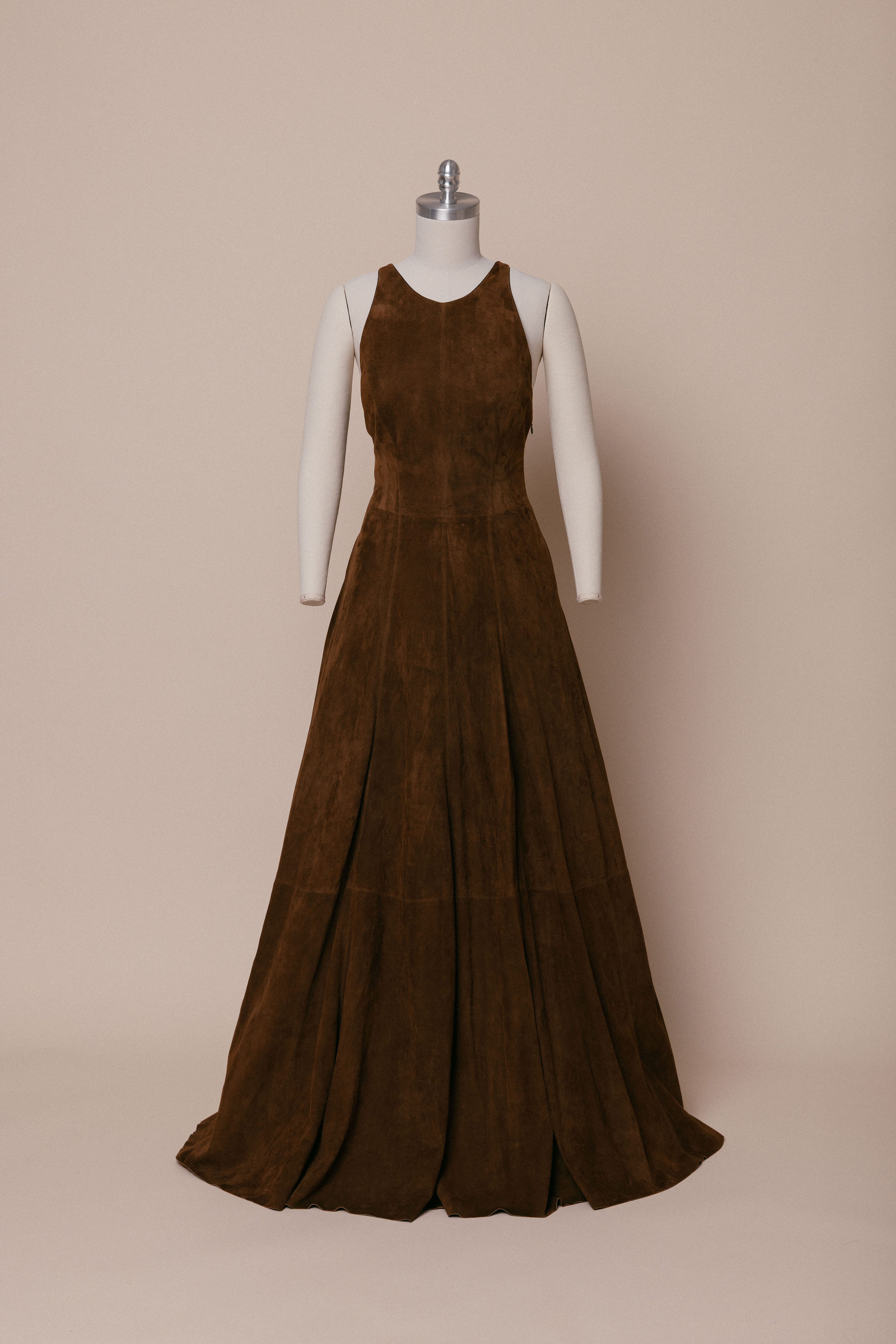 A 2007 Ralph Lauren runway suede gown on a dress form against an ivory backdrop