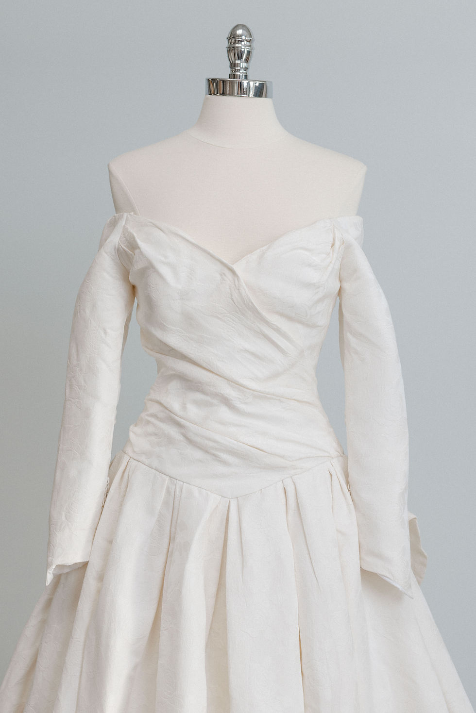 Thumbnail: Bodice and sleeve detail of 1994 Christian Dior wedding dress in Atlanta bridal shop