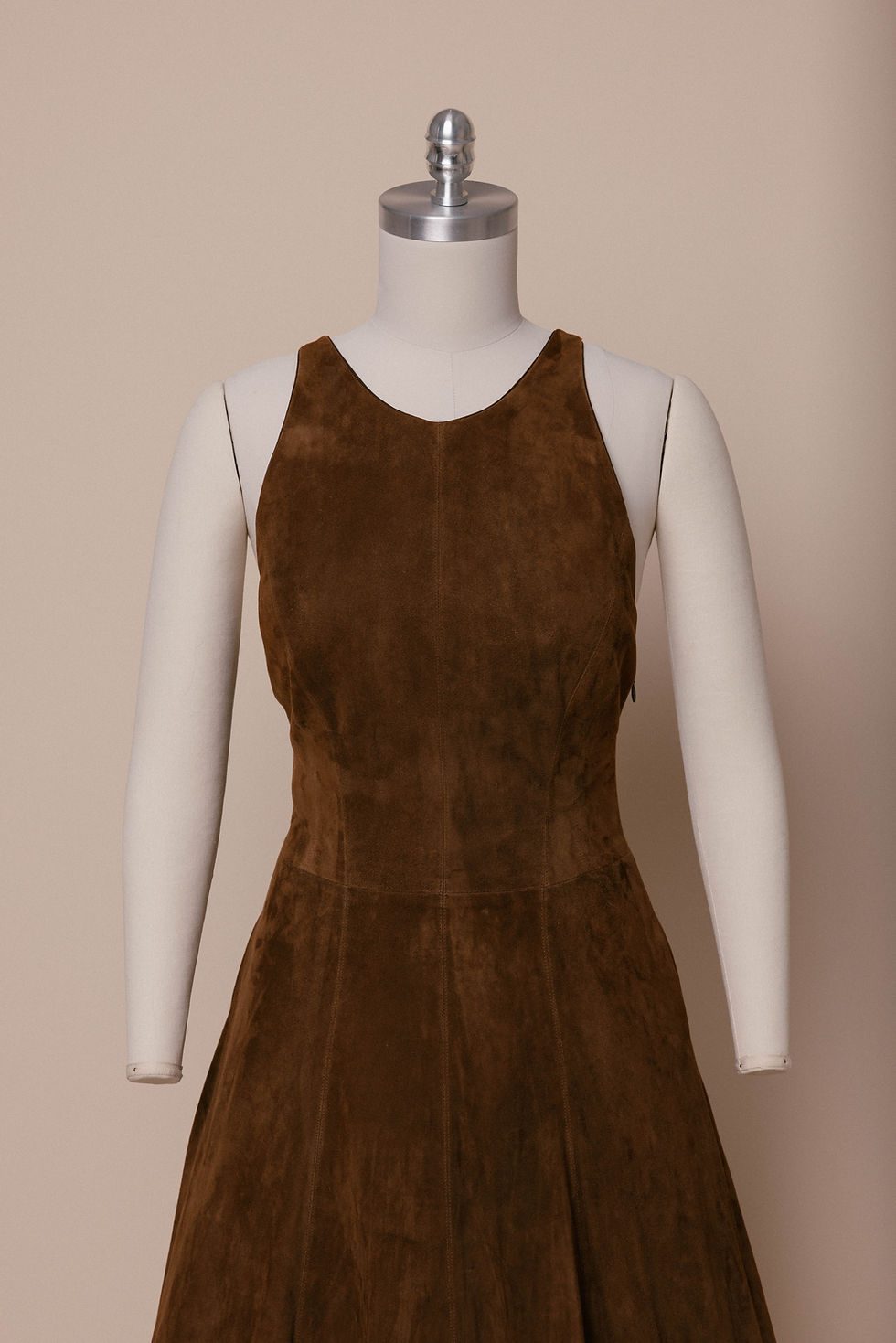 A 2007 Ralph Lauren runway suede gown on a dress form against an ivory backdrop