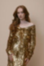 Model wearing archival Vivienne Westwood gold label dress covered in gold sequins