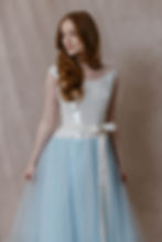 Red haired model wearing 1995 Vera Wang wedding dress with blue skirt and sequin bodice