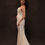Thumbnail: Model wearing clean vintage Vera Wang wedding dress against brown backdrop