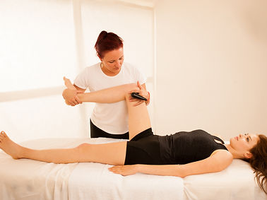 Physiotherapist doing Tecar therapy alterantive treatment on a woman patient.jpg