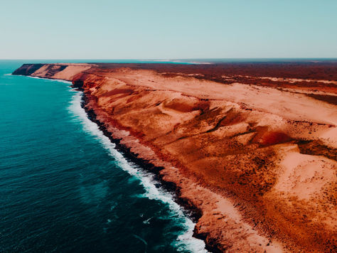 Aerial view of the Kimberley Coast Australia red sandstone cliffs meeting turquoise ocean in Western Australia