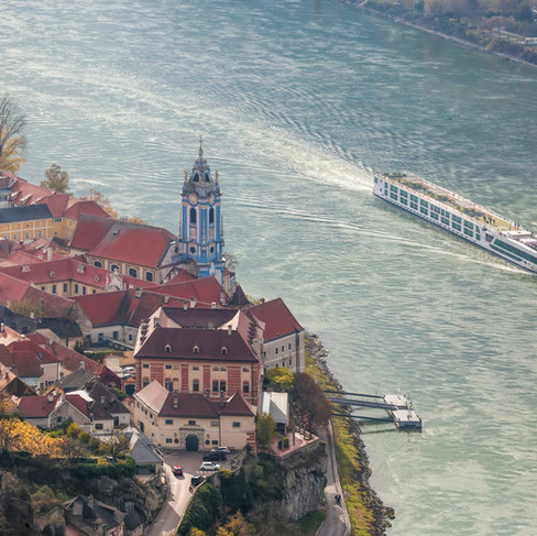 Luxury river cruise ship near Dürnstein, Austria, with the town in the foreground