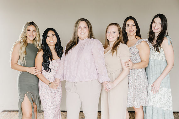 Five women posing in mauve, light pink, tan and sage green color palettes