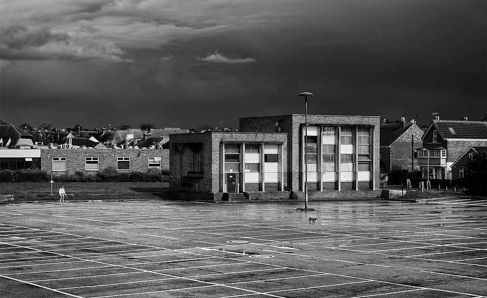 Girl and Dog at play in a deserted car park during Covid Lockdown