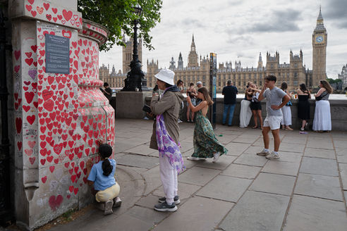Covid Memorial Wall and the Houses of Parliament beside the River Thames