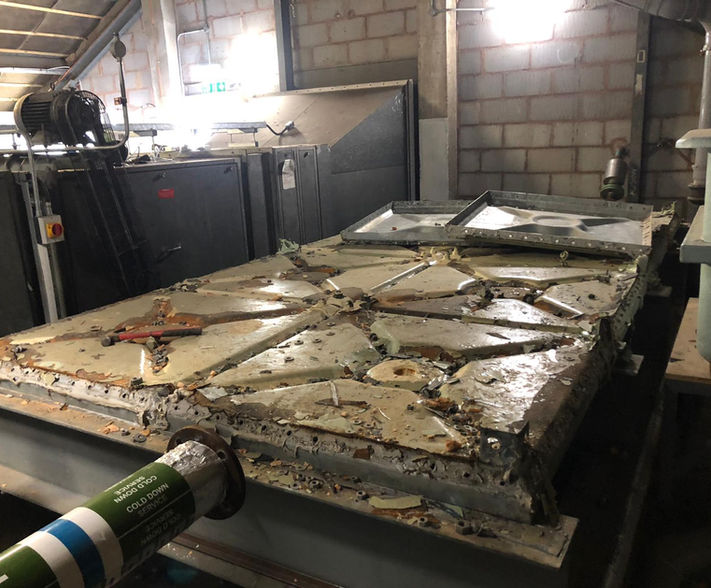 Base of corroded cold water tank.