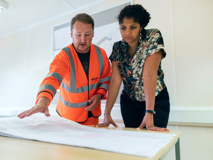 Engineers looking at a schematic