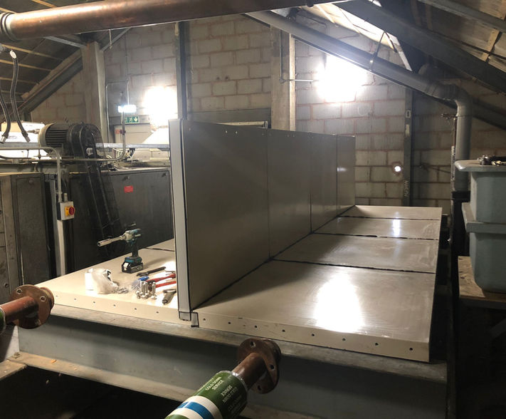 Sectional water tank being assembled.