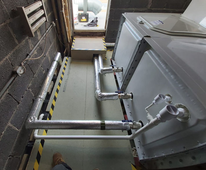 Sectional water tank with insulated pipework.