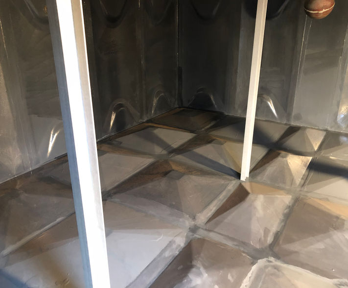 Coat of grey polyurethane on sectional water tank panels.