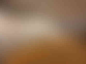 Gallery hallway with colorful paintings displayed on walls.