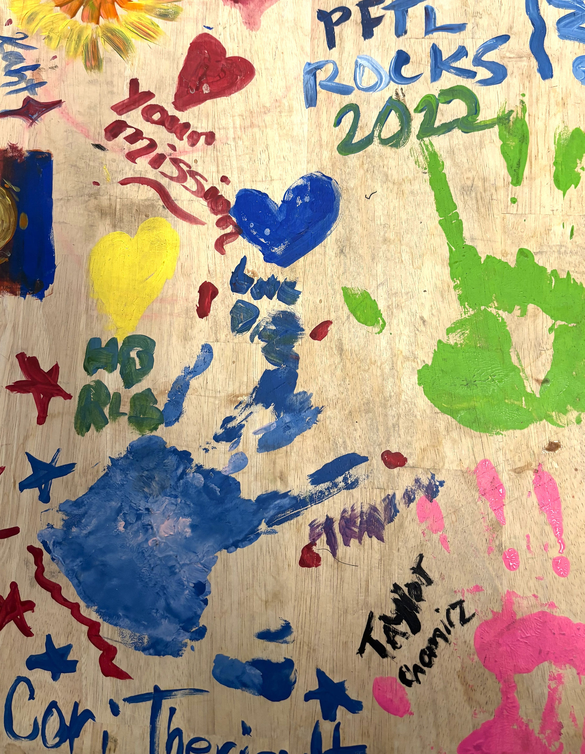 A hand-painted table with colorful designs and artwork on its surface.