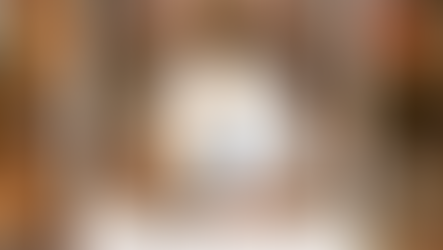 Background of colorful autumn leaves with a Polaroid photo of a lit candle and the words ‘Be the Light,’ symbolizing hope, warmth, and support during the fall season.