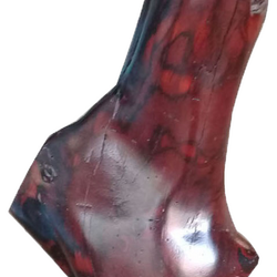 Close-up of a wooden sculpture with rich red and brown tones. Diamond Tropical Hardwoods