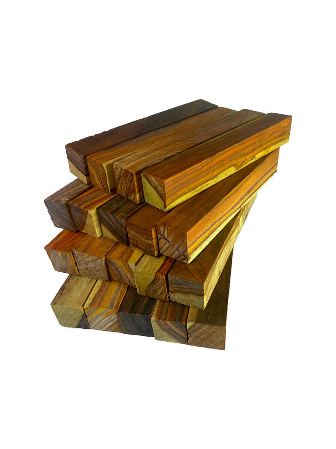 Stack of highly figured wood lumber on white background, Diamond Tropical Hardwoods.