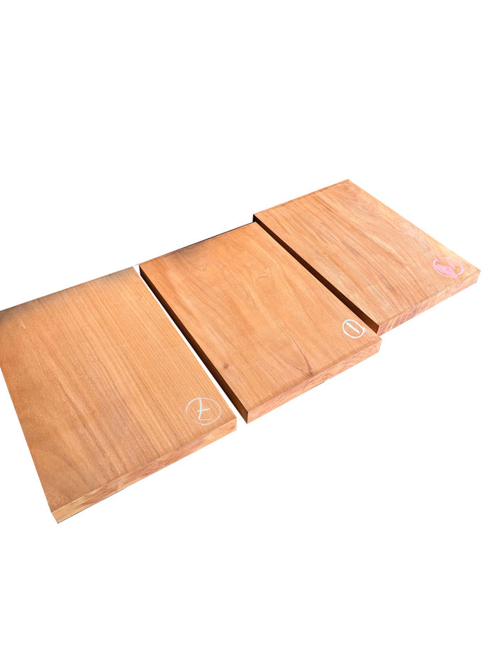 Three wooden boards with visible text and texture, Diamond Tropical Hardwoods.