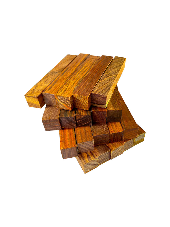 Stacked highly figured mahogany lumber blocks, close up view, on a white background.