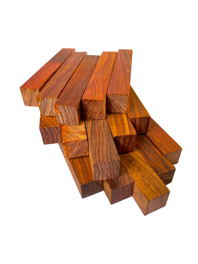 Pile of highly figured lumber, close up, warm wood tones, Diamond Tropical Hardwoods.