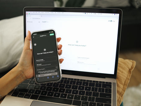 A phone and laptop using AI-assisted search