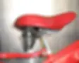 Bicyle seat and red bicycle