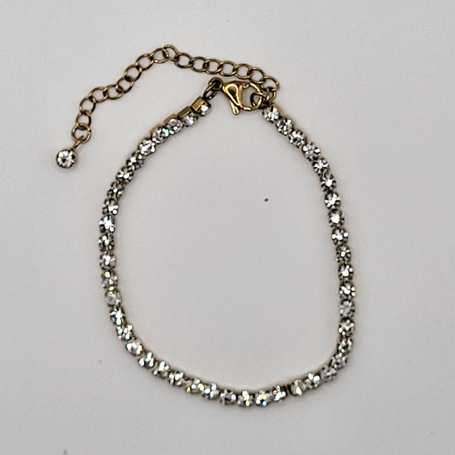 Bracelet fin argenté avec strass clairs, fermoir chaîne couleur or.