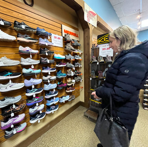 woman looking at shoes at dale's bootery in whitewater wisconsin
