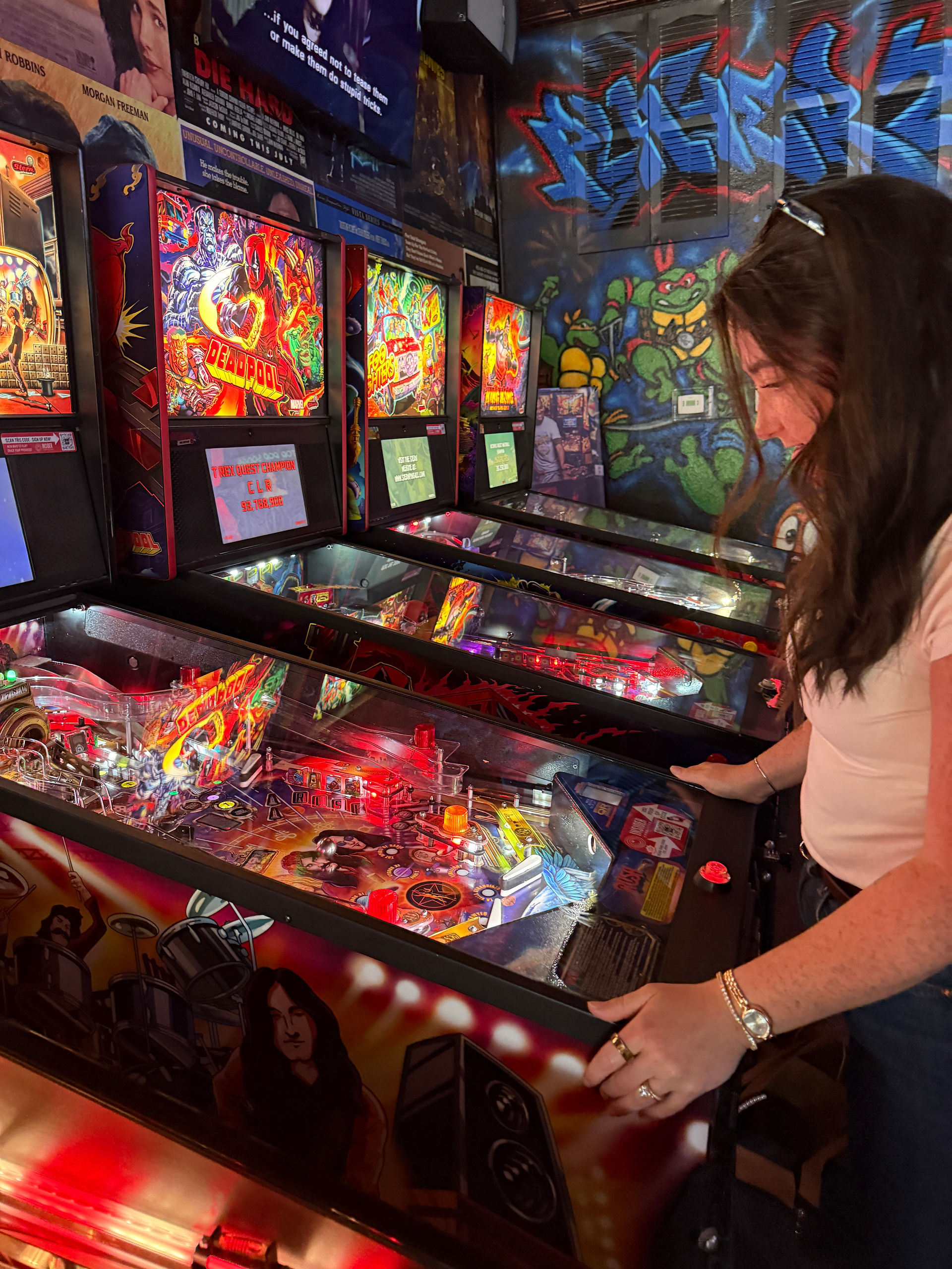 girl playing pinball machine player 2 arcade bar