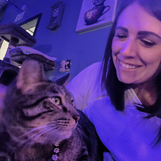 girl holding white and gray striped cat inside baristacat cafe in whitewater wisconsin