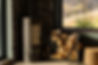 modern-stove-near-pile-firewood-beside-large-window-with-view-mountains-scene-showing-cozy