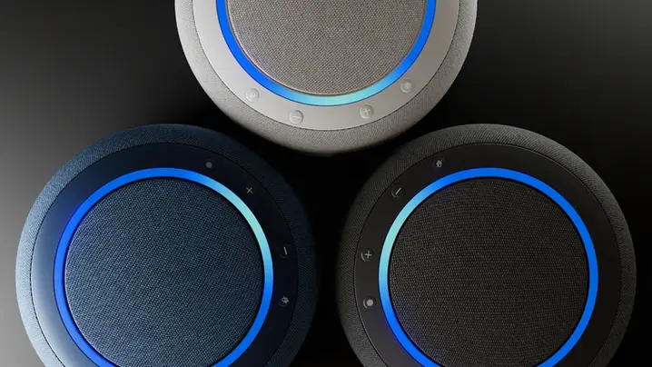 Top view of three Amazon Echo Studio smart speakers in blue, gray, and white with glowing LED rings