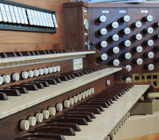 Close up view of the chapel pipe organ keyboard and stops
