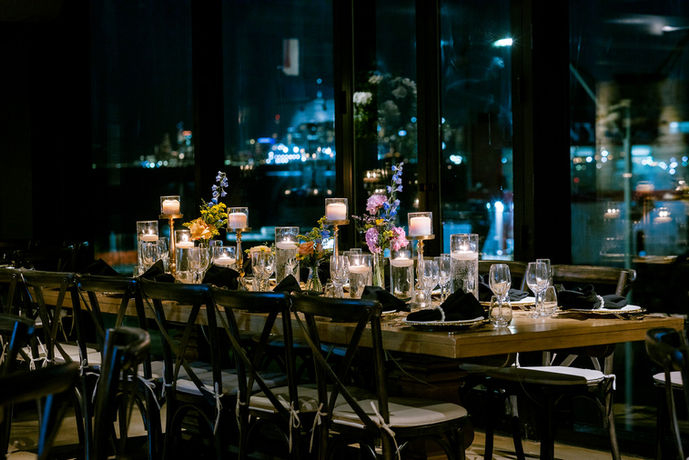 Candlelit event table with city view at night