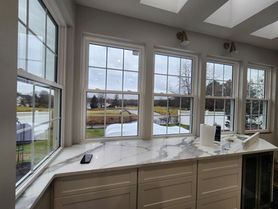 Picture window with a quartz sill overlooking the yard from a New Jersey kitchen renovation