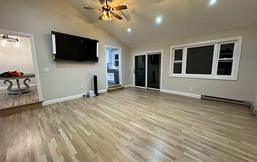 Living room renovation with vaulted ceiling, wall-mounted TV and white oak flooring in New Jersey