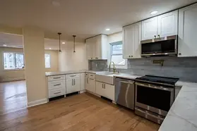 Kitchen with white shaker cabinets, a stainless range and tile backsplash remodeled in New Jersey
