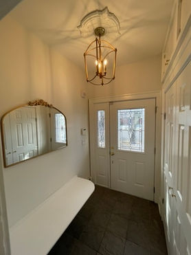 Front entry with an arched mirror and glass door from a New Jersey home renovation